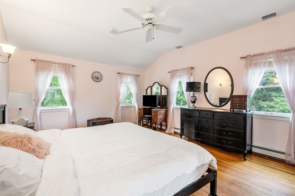 11 Sycamore Road Scituate, MA 02066 - Photo 25 of 39 a bedroom with a bed a mirror on dresser and a window