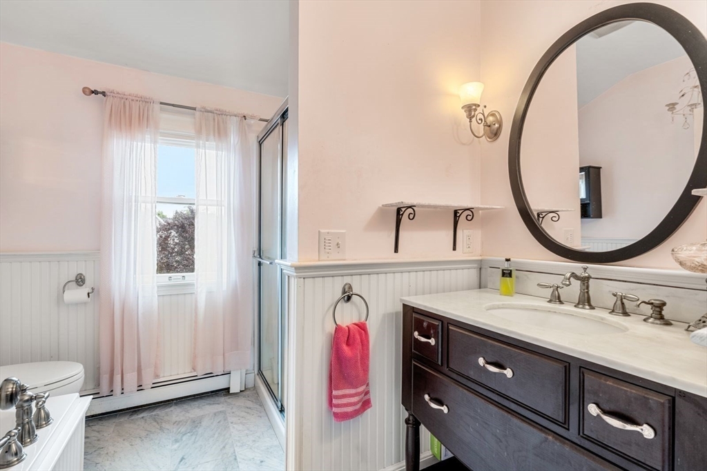 11 Sycamore Road Scituate, MA 02066 - Photo 27 of 39 a bathroom with a sink and a mirror