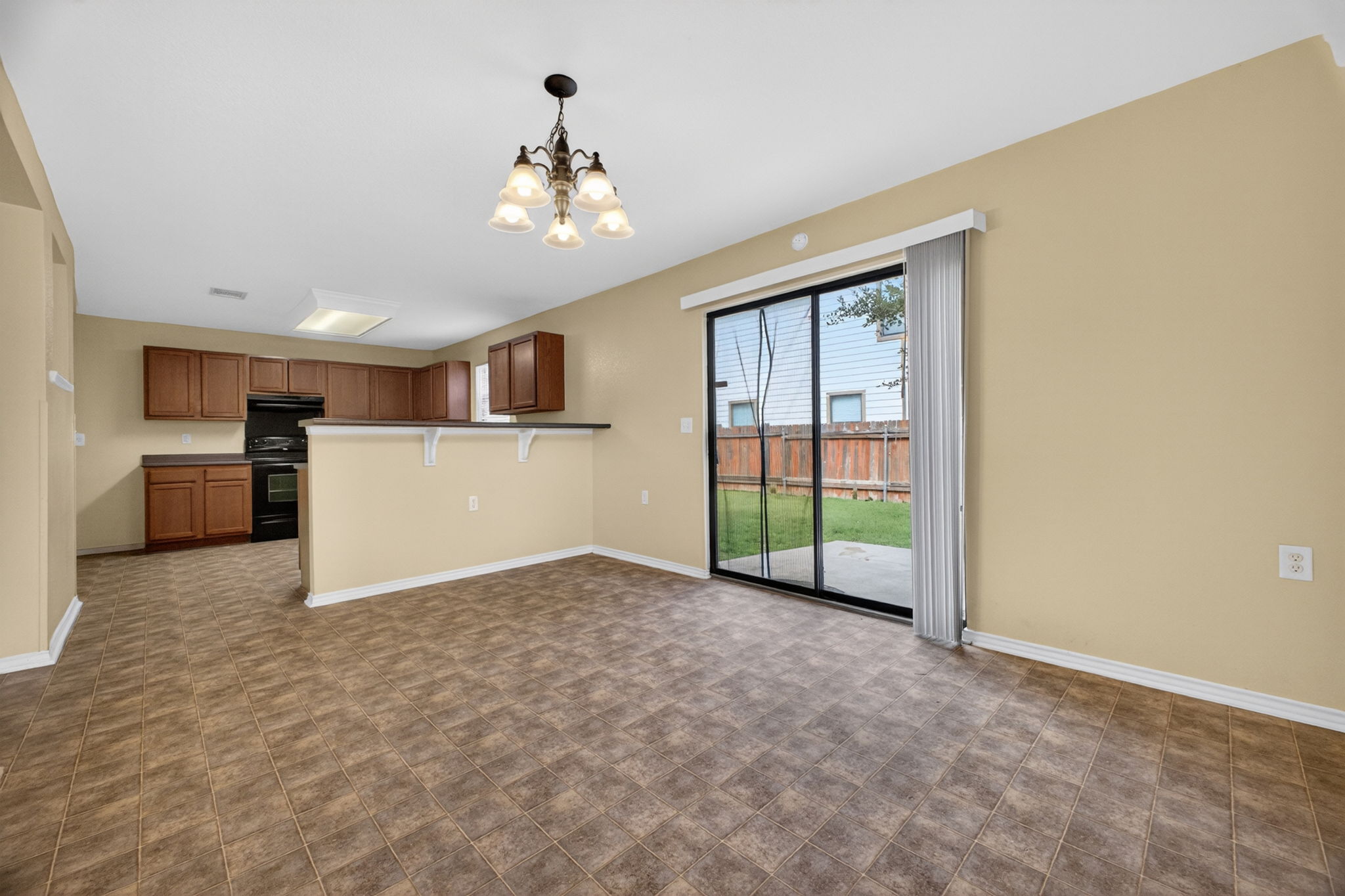 8813 Wiley Way Austin, TX 78747 - Photo 8 of 39 A sliding glass door opens to the private yard, complementing the spacious kitchen and dining area