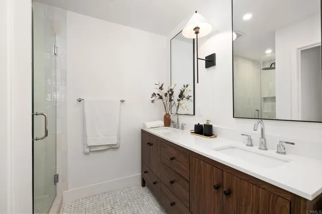 a bathroom with a double vanity sink mirror and double