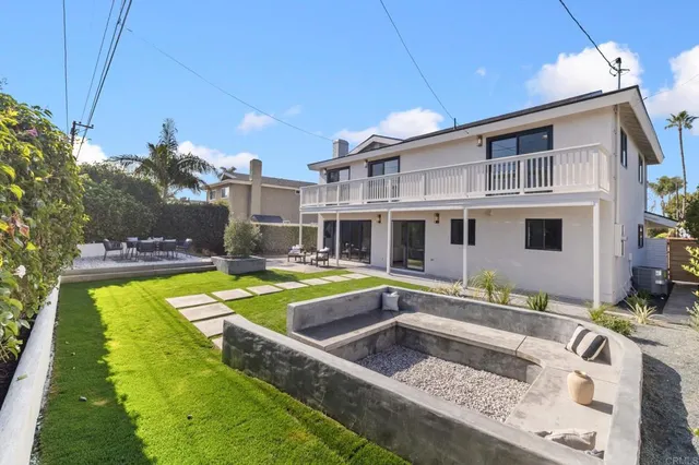 a view of a house with pool and chairs