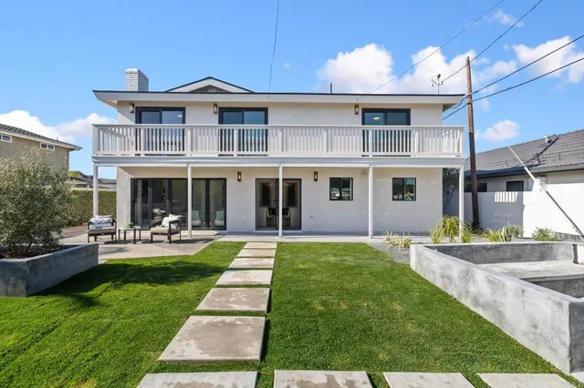 a front view of a house with swimming pool having outdoor seating