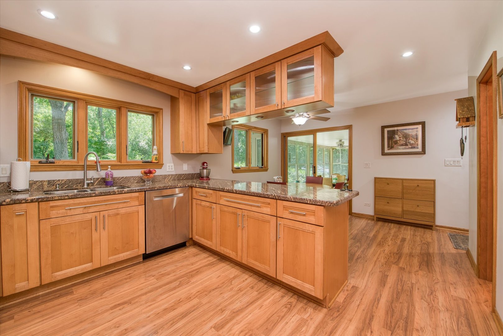 1196 Nottingham Lane Elgin, IL 60120 - Photo 16 of 45 a large kitchen with kitchen island granite countertop wooden floors and wide window