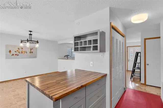 a view of a hallway view with wooden floor and living room