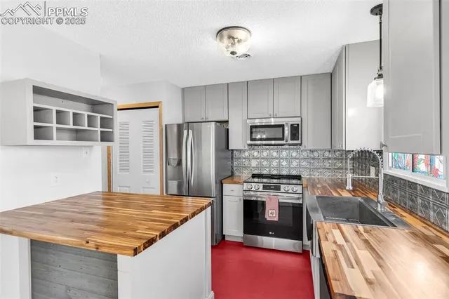 a kitchen with kitchen island a stove sink and microwave