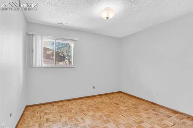 a bedroom with a bed and a dresser with rug