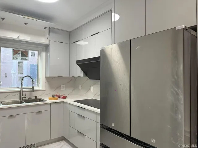 a kitchen with stainless steel appliances a refrigerator and sink