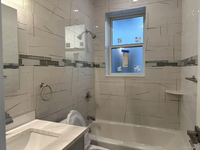 a bathroom with a bathtub and shower