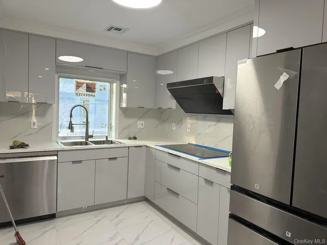 a kitchen with a sink and refrigerator