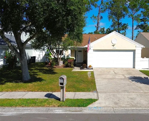 a view of a yard in front view of a house