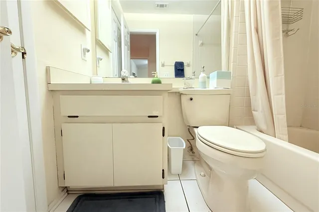 a bathroom with a sink a toilet a mirror and shower