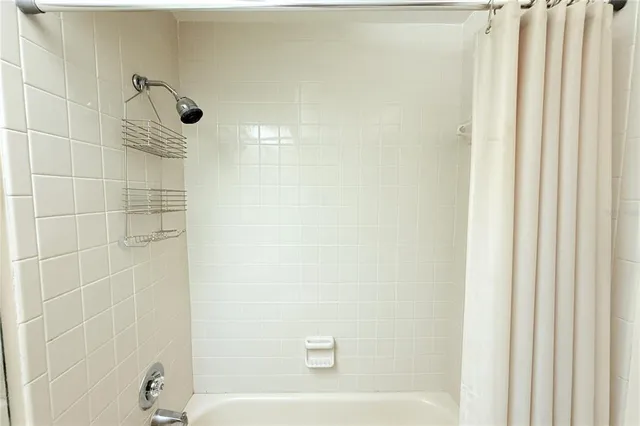 a bathroom with a shower and a bathtub