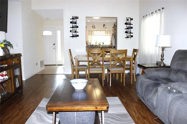 a view of a dining room with furniture and wooden floor