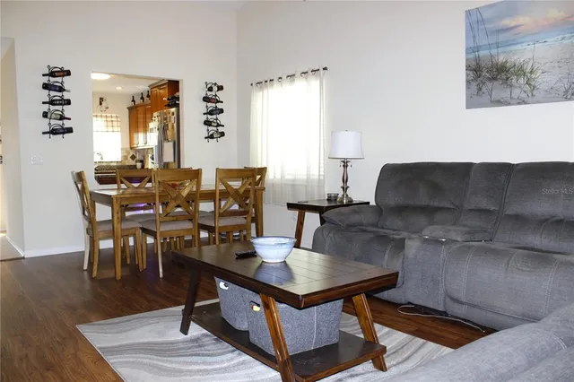 a living room with furniture a rug and a window