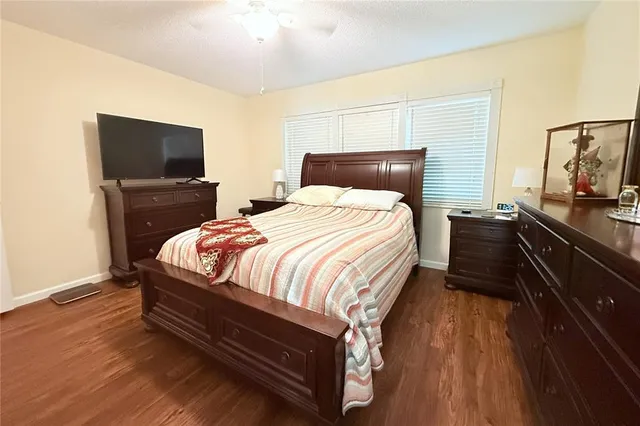 a bedroom with a bed and flat screen tv