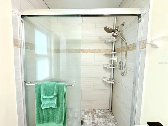 a bathroom with a glass shower door