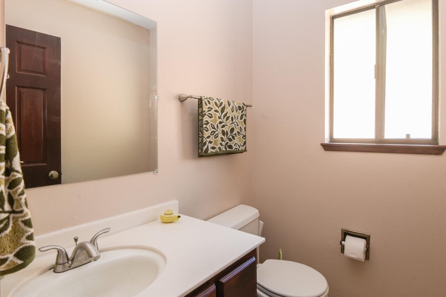 15223 Perry Lane Morgan Hill, CA 95037 - Photo 17 of 31 a bathroom with a sink vanity mirror and toilet