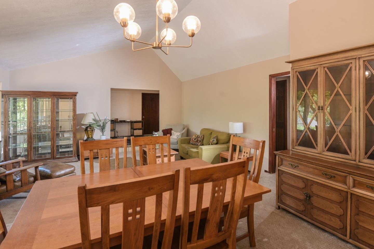 15223 Perry Lane Morgan Hill, CA 95037 - Photo 20 of 31 a view of a dining room with furniture a chandelier and large windows