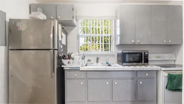 a white refrigerator freezer sitting inside of a kitchen