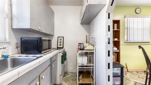 a kitchen with stainless steel appliances a stove a sink and a microwave