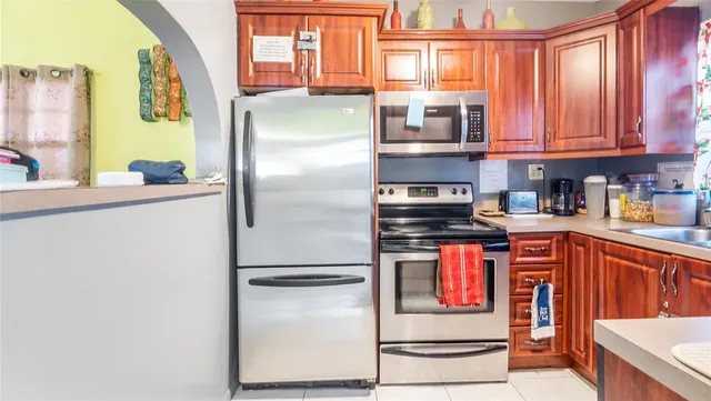 a kitchen with stainless steel appliances granite countertop a refrigerator and a stove top oven