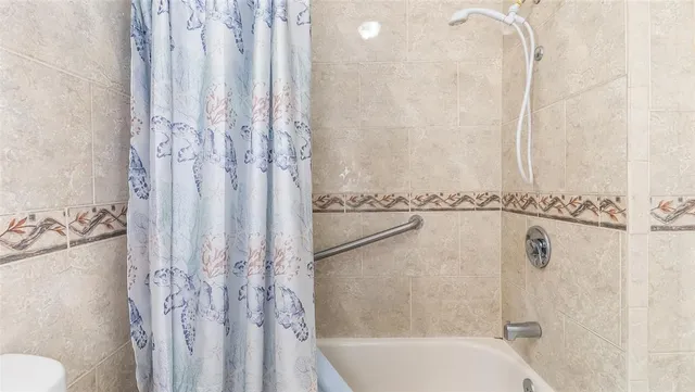 a bathroom with a shower curtain and a toilet