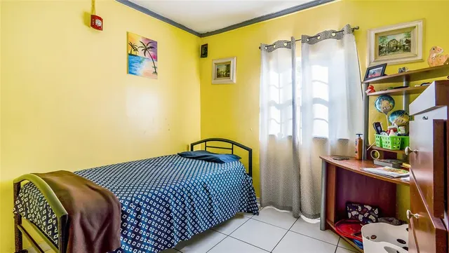 a bedroom with a bed and a dresser