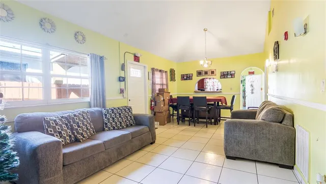 a living room with furniture and a chandelier