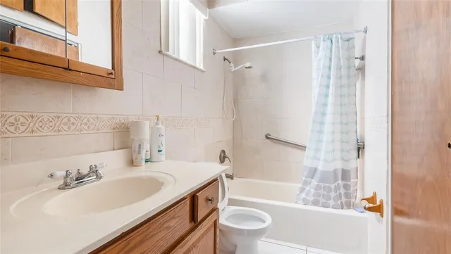 a bathroom with a sink toilet tub and shower