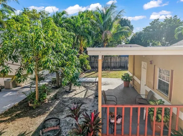 a view of a house with backyard and sitting area