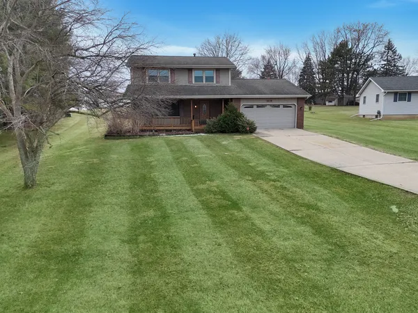 a front view of house with yard and trees