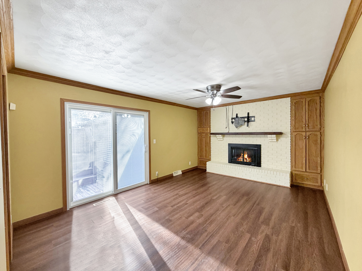 1419 Finch Street Freeport, IL 61032 - Photo 16 of 30 a view of an empty room with wooden floor fireplace and a window