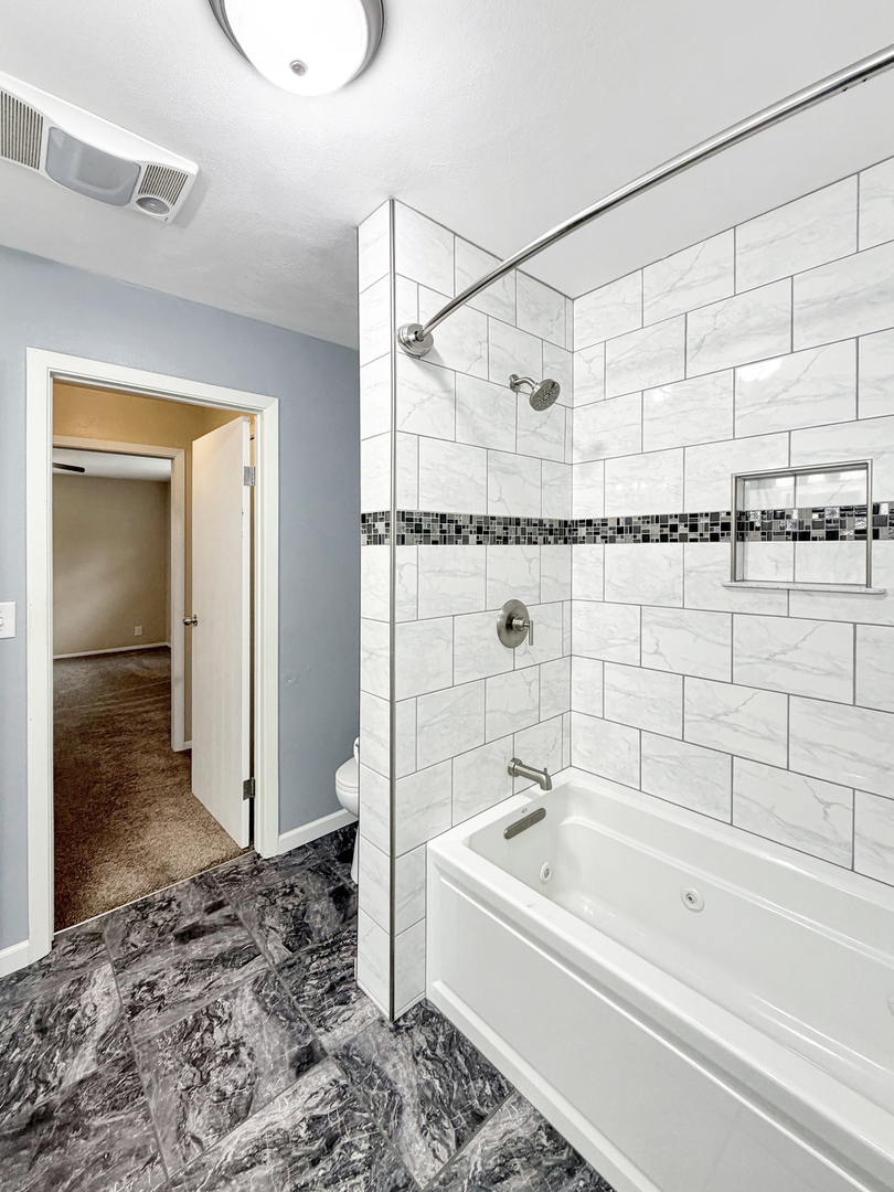 1419 Finch Street Freeport, IL 61032 - Photo 19 of 30 a bathroom with a bathtub and a shower