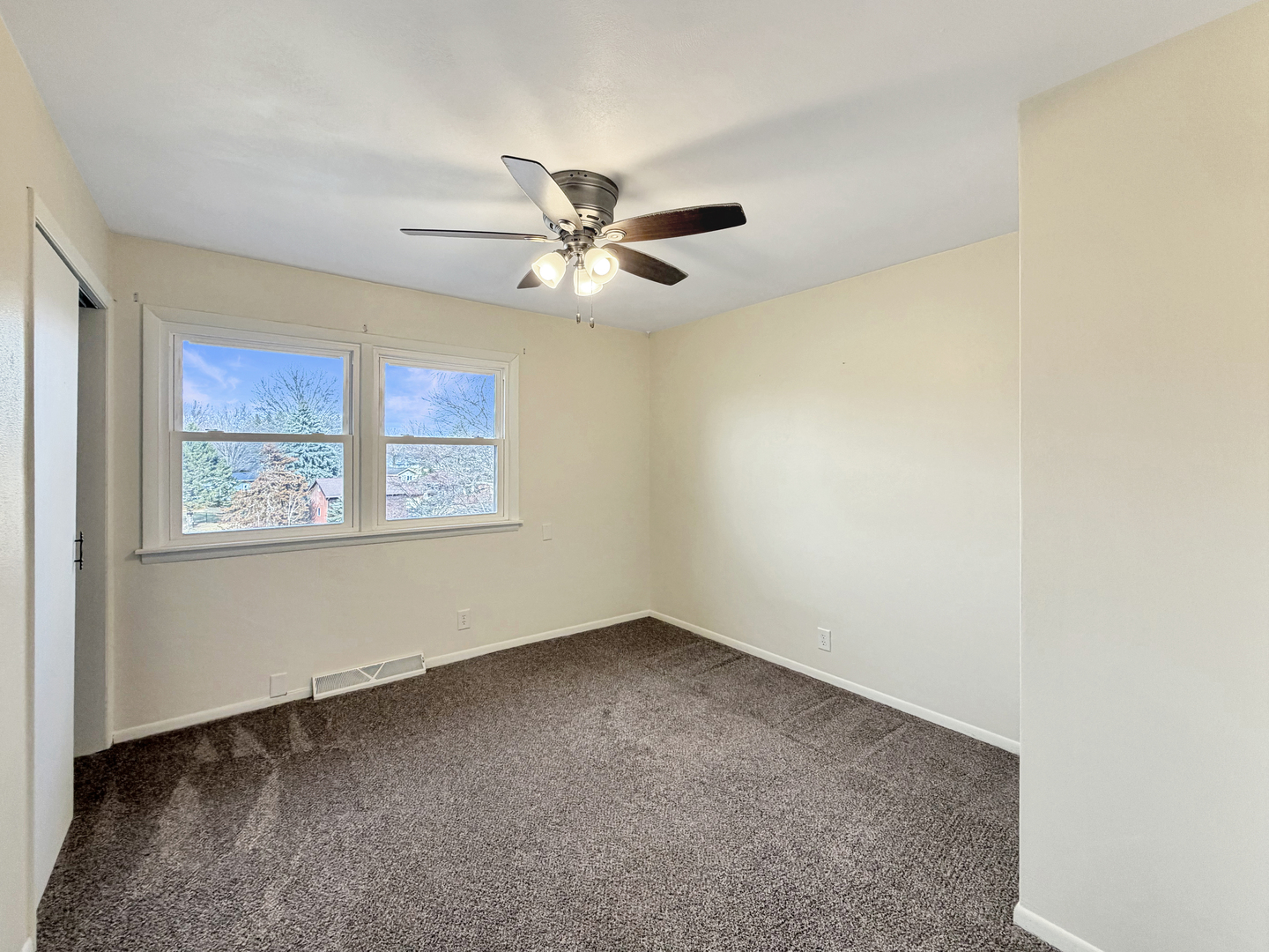 1419 Finch Street Freeport, IL 61032 - Photo 21 of 30 an empty room with windows and fan