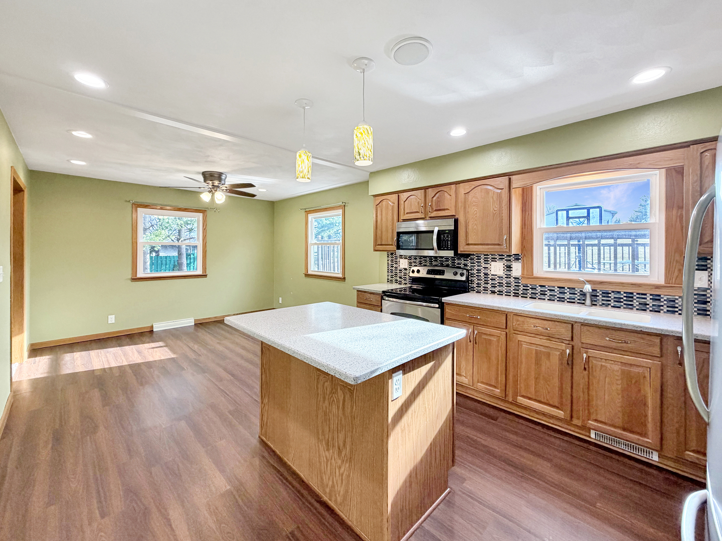 1419 Finch Street Freeport, IL 61032 - Photo 9 of 30 a kitchen with stainless steel appliances granite countertop a sink stove and wooden floor