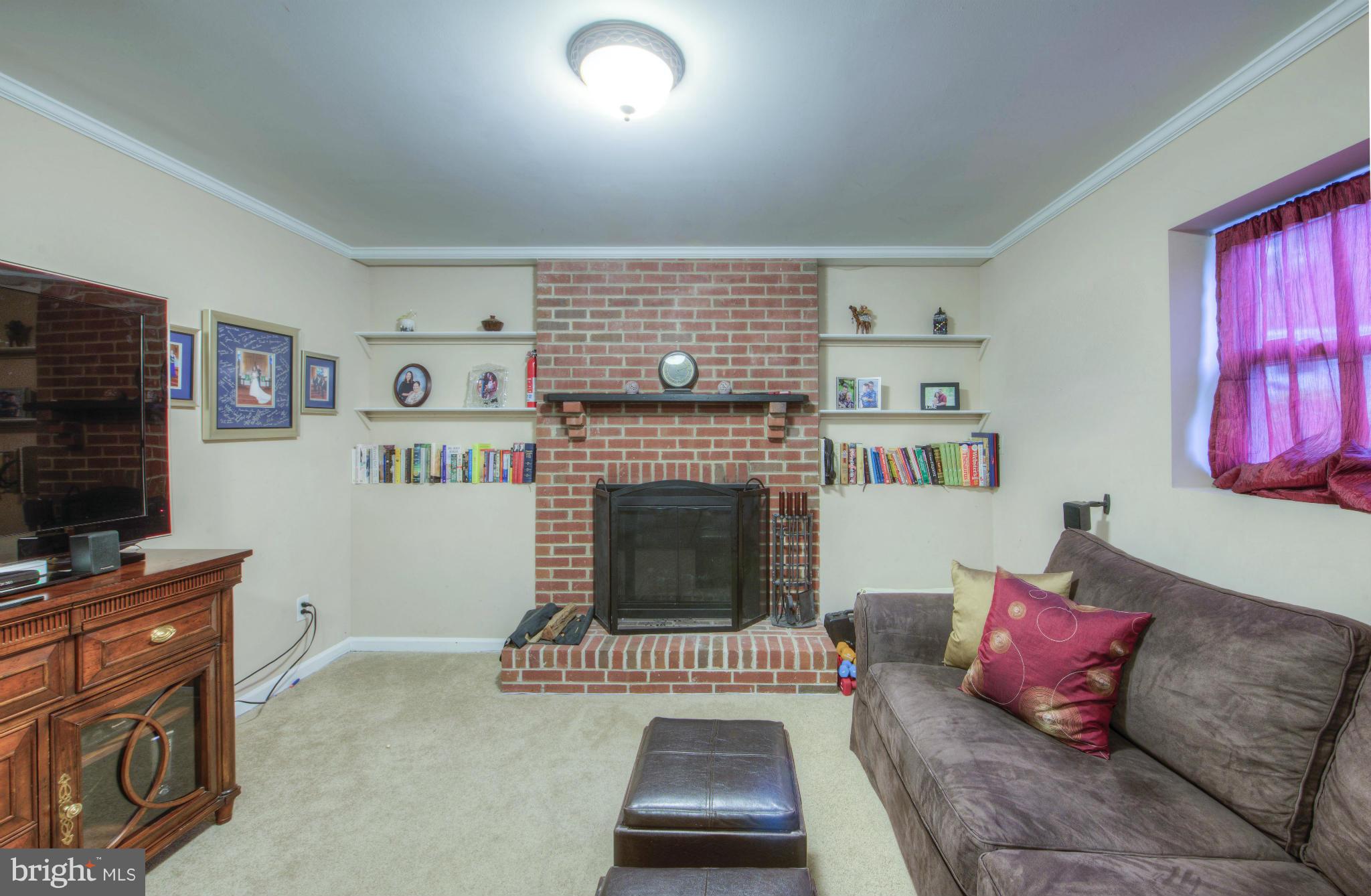 55 Buck Road Stafford, VA 22556 - Photo 16 of 19 a living room with furniture a flat screen tv and a fireplace