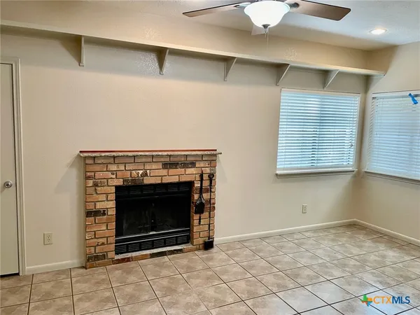 a view of empty room with fireplace