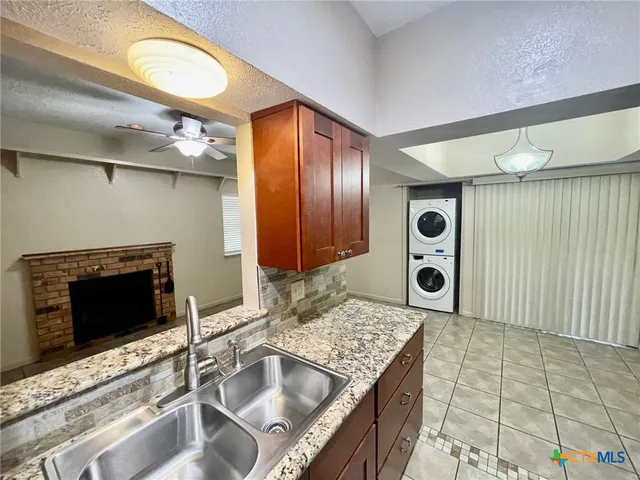 a kitchen with a sink and a refrigerator