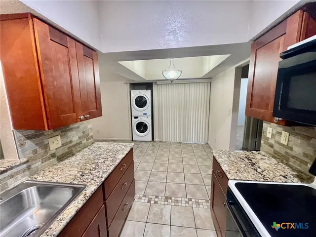 a kitchen with a sink and a stove top oven