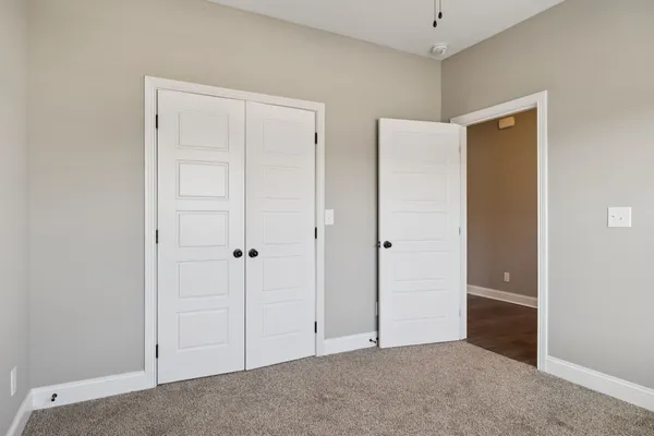 a view of an empty room with closet area