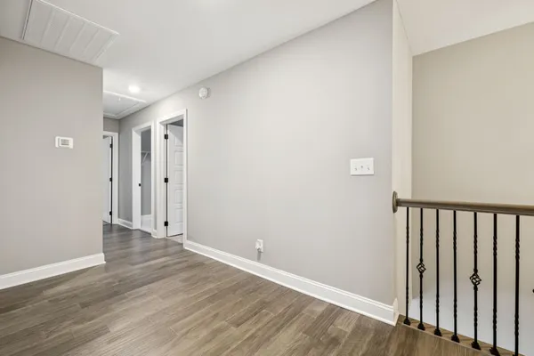 an empty room with chandelier fan