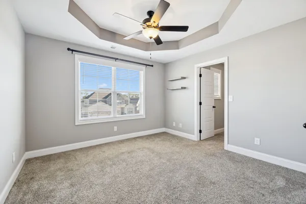 a view of room with window and ceiling fan