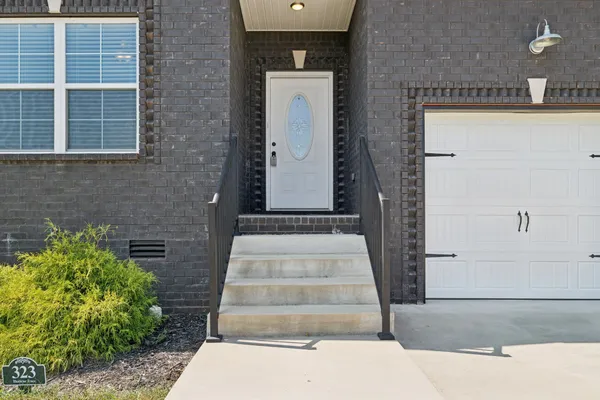 a front view of a house with stairs