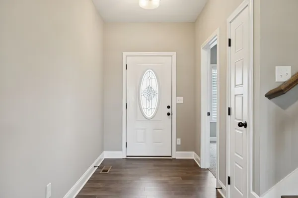 a view of an entryway with wooden floor