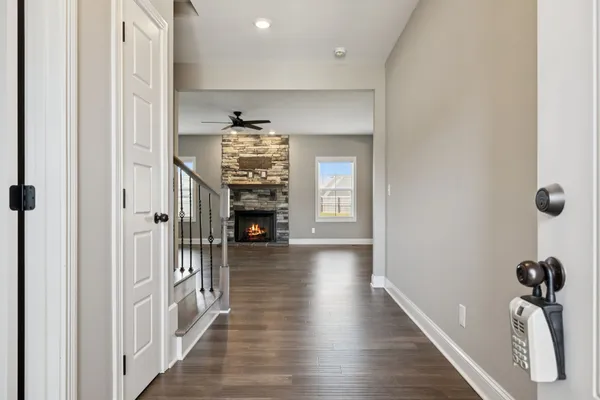 a view of a hallway with wooden floor and staircase