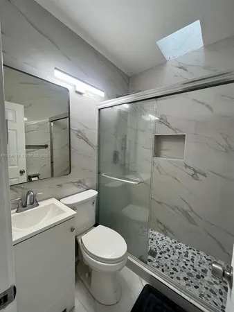 a bathroom with a sink toilet and shower