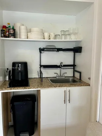 a kitchen with a sink a stove and cabinets