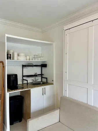 a kitchen with stainless steel appliances a refrigerator and cabinets