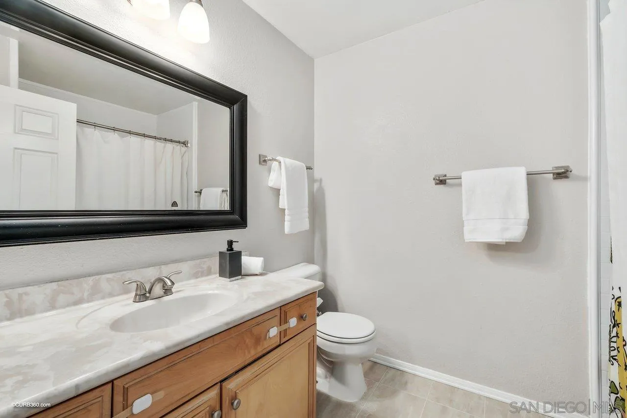 2648 Alpine Boulevard, Unit B Alpine, CA 91901 - Photo 15 of 25 a bathroom with a granite countertop sink and a mirror