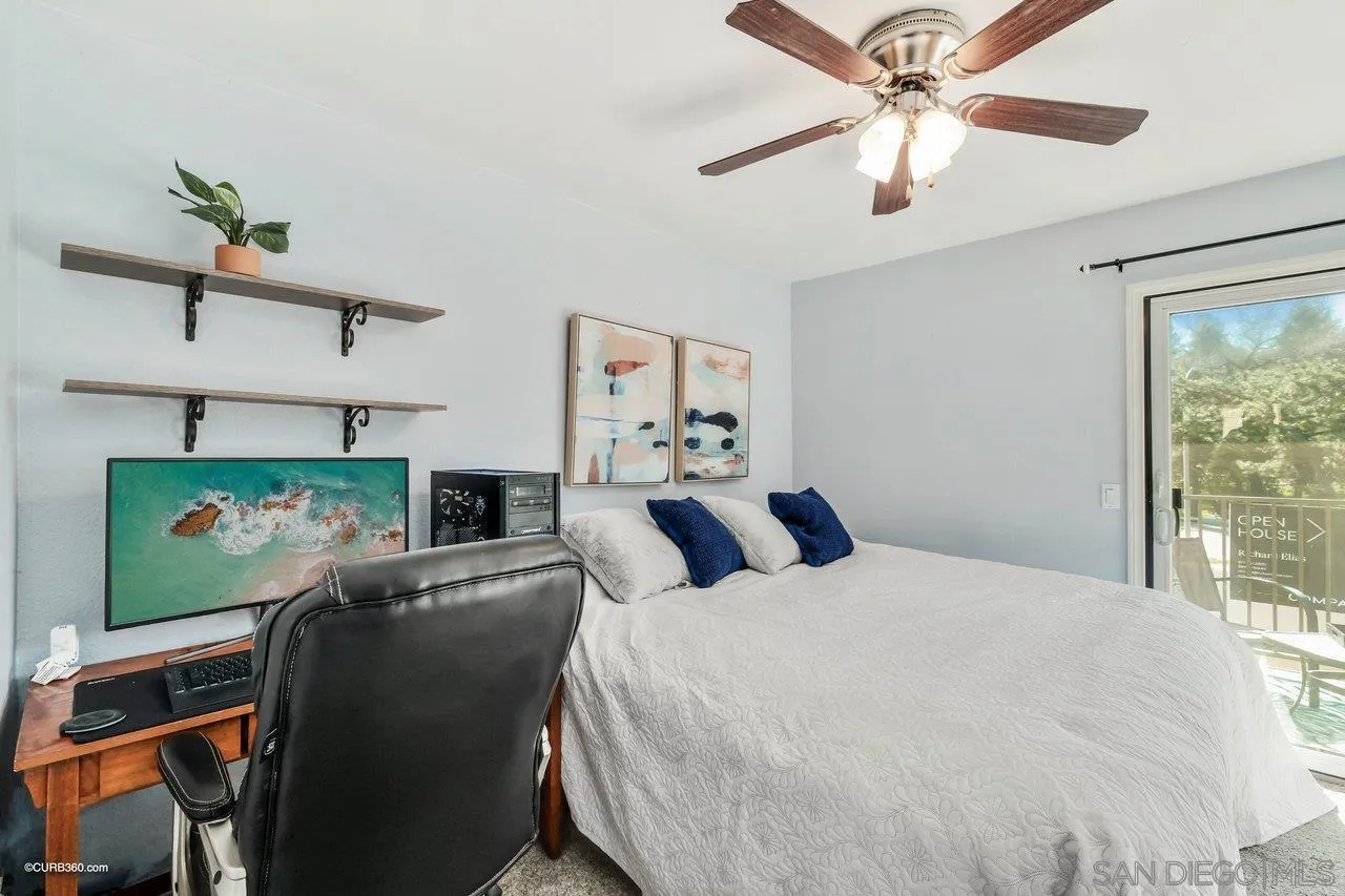 2648 Alpine Boulevard, Unit B Alpine, CA 91901 - Photo 17 of 25 a bedroom with a bed a ceiling fan and a window